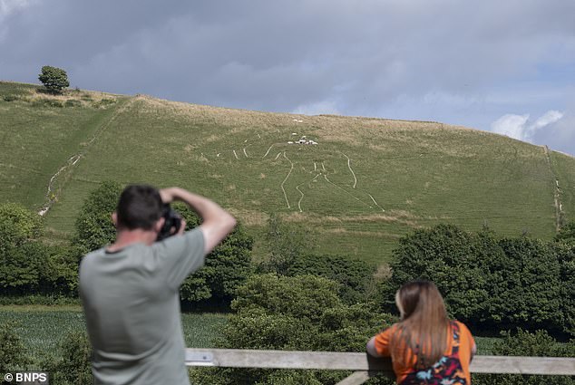 Experts restore Britain's iconic Cerne Abbas Giant with 17 tonnes of chalk.